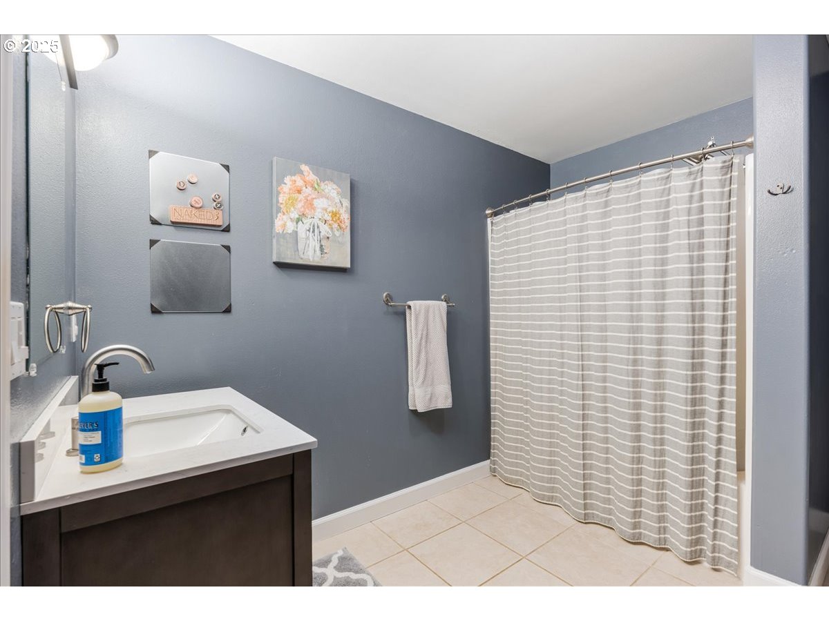 30062 Maple Drive Rainier, OR 97048 - Photo 23 of 47 a bathroom with a sink a mirror and window