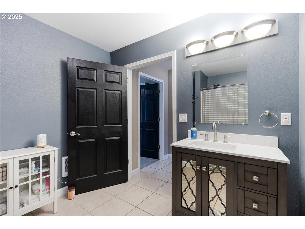 30062 Maple Drive Rainier, OR 97048 - Photo 24 of 47 a bathroom with a sink a mirror and shower