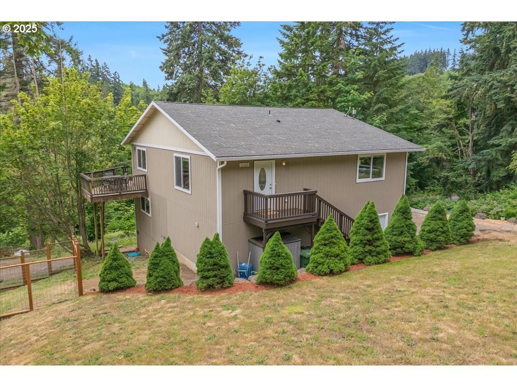 30062 Maple Drive Rainier, OR 97048 - Photo 32 of 47 a backyard of a house with plants and trees