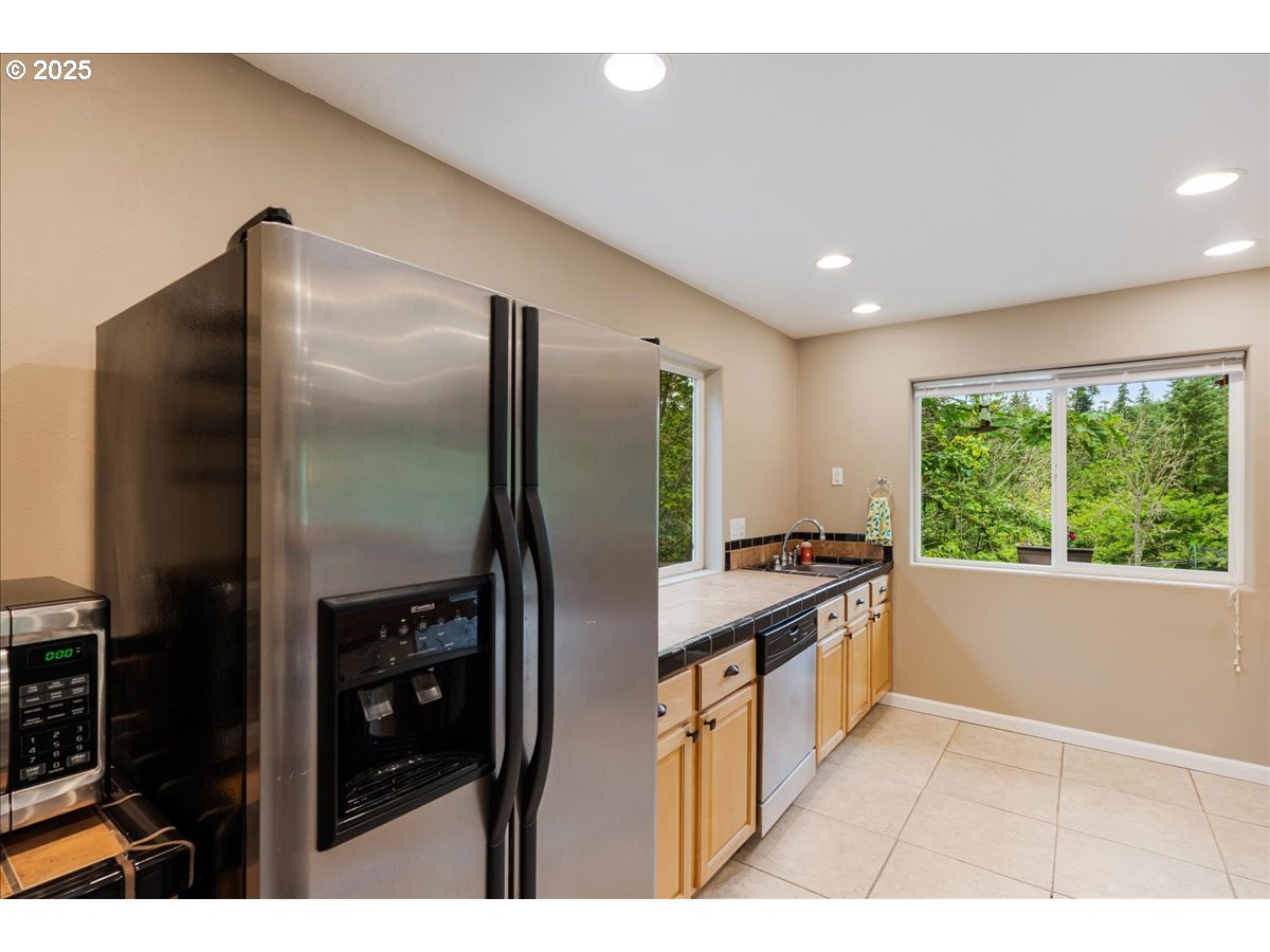 30062 Maple Drive Rainier, OR 97048 - Photo 10 of 47 a kitchen with stainless steel appliances granite countertop a refrigerator a stove and a sink