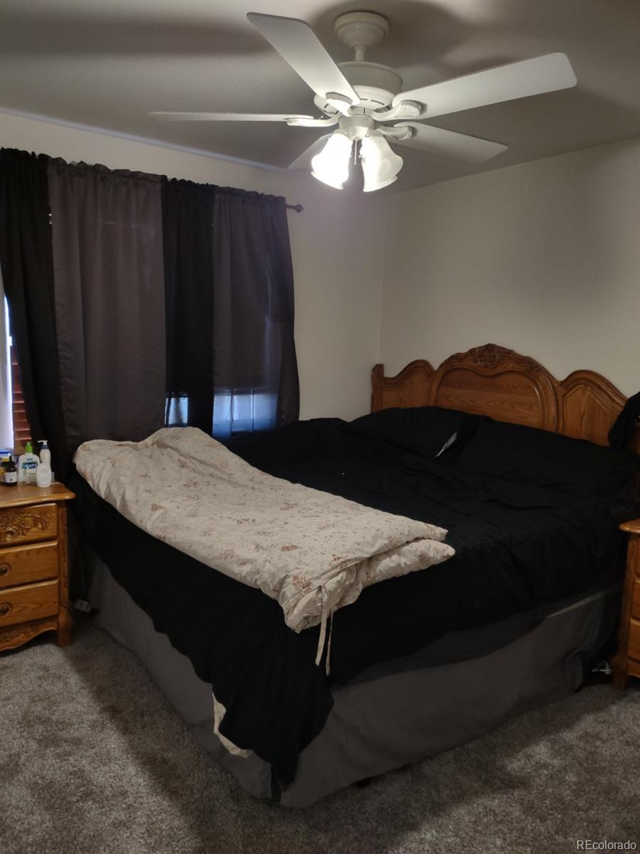 5342 Roadrunner Avenue Firestone, CO 80504 - Photo 20 of 21 a bedroom with a bed and a chandelier