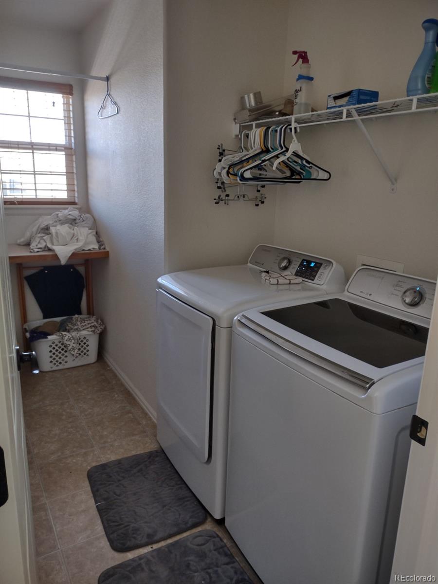 5342 Roadrunner Avenue Firestone, CO 80504 - Photo 21 of 21 a utility room with dryer and washer
