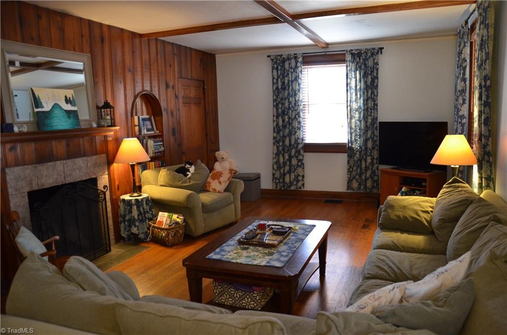 Real Wood Paneling + Wood Burning Fireplace in Large Great Room.