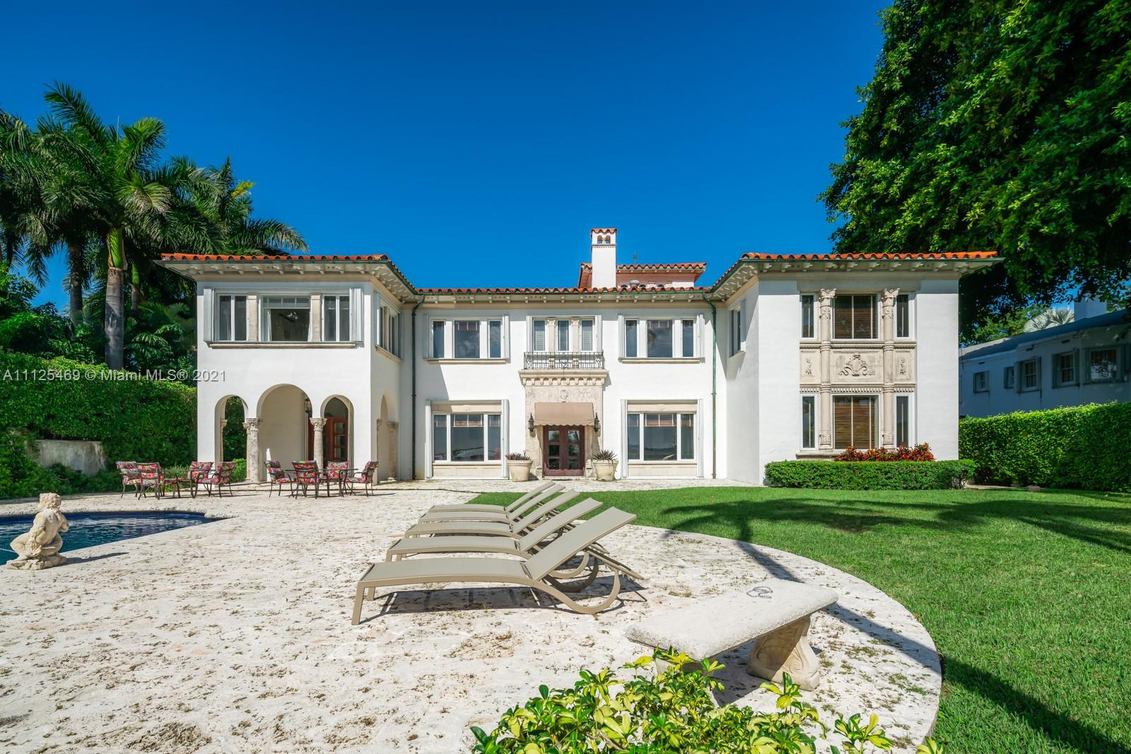 3029 Brickell Avenue Miami, FL 33133 - Photo 17 of 41 a front view of a house with a garden and trees