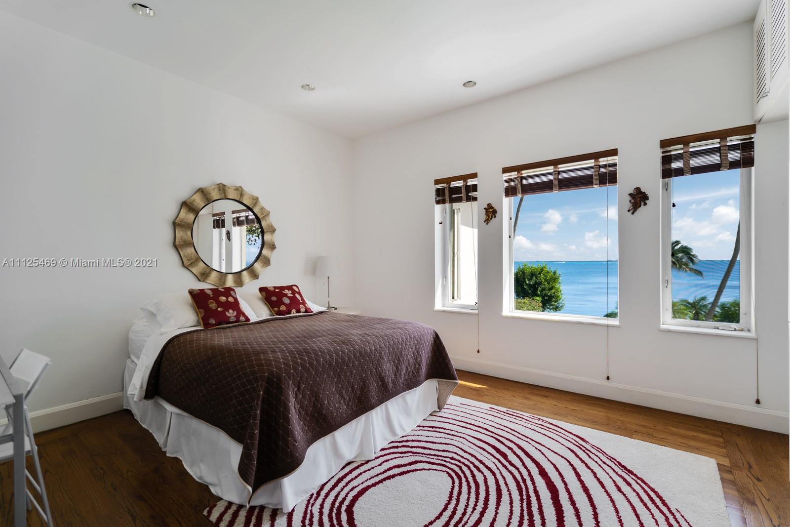 3029 Brickell Avenue Miami, FL 33133 - Photo 36 of 41 a bedroom with a bed a window and mirror