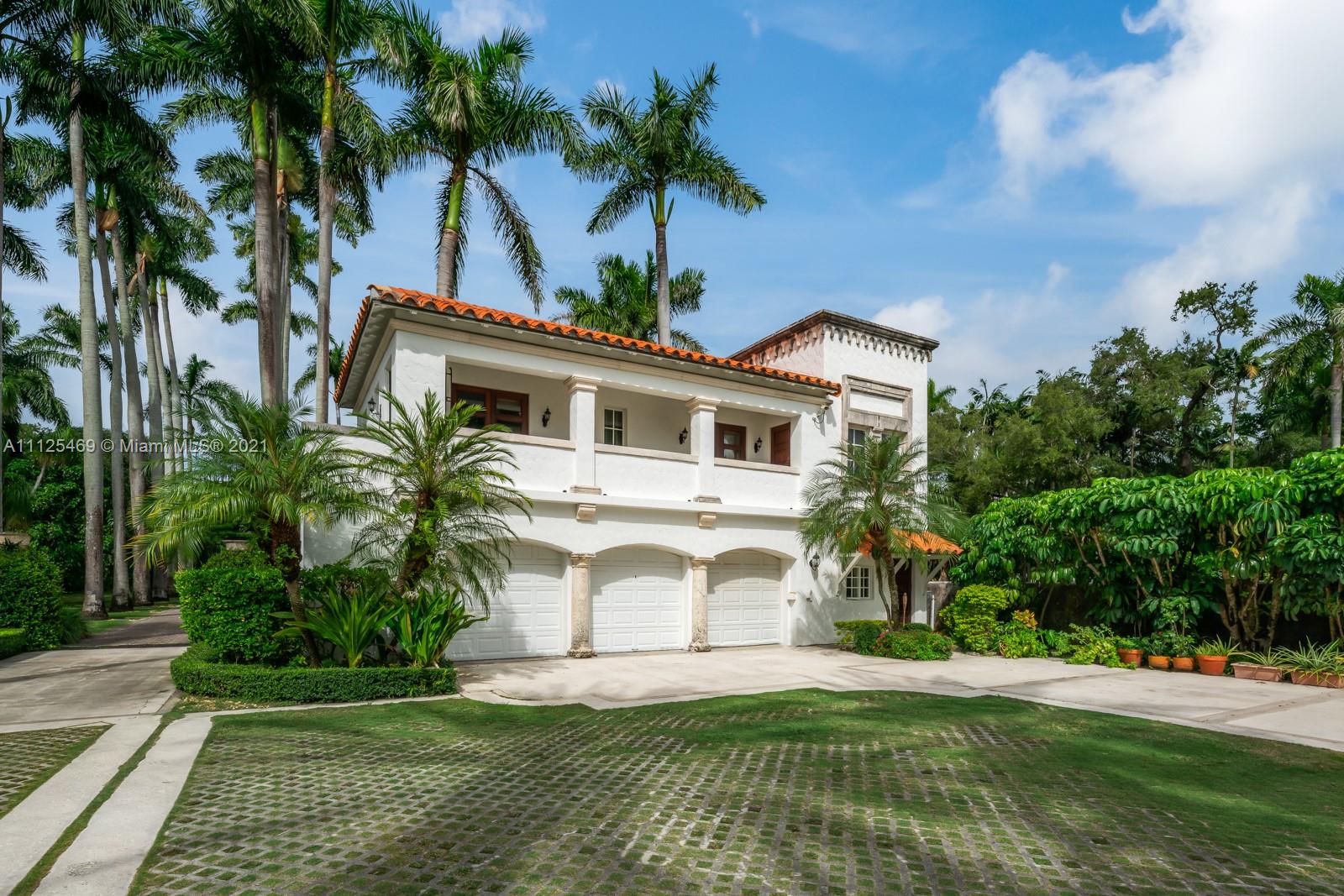 3029 Brickell Avenue Miami, FL 33133 - Photo 7 of 41 a front view of a house with a garden and yard