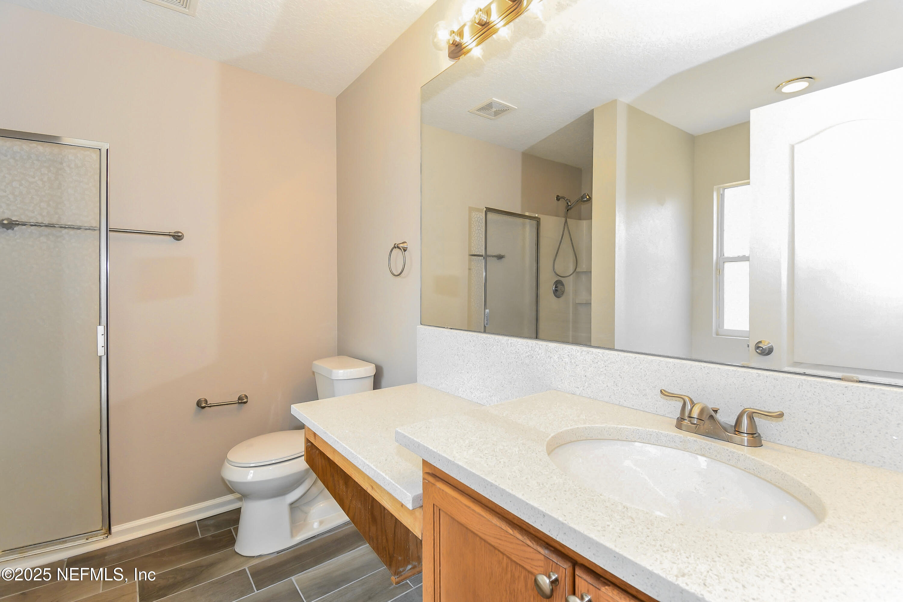 3786 Robena Road Jacksonville, FL 32218 - Photo 11 of 16 a bathroom with a granite countertop sink toilet and shower