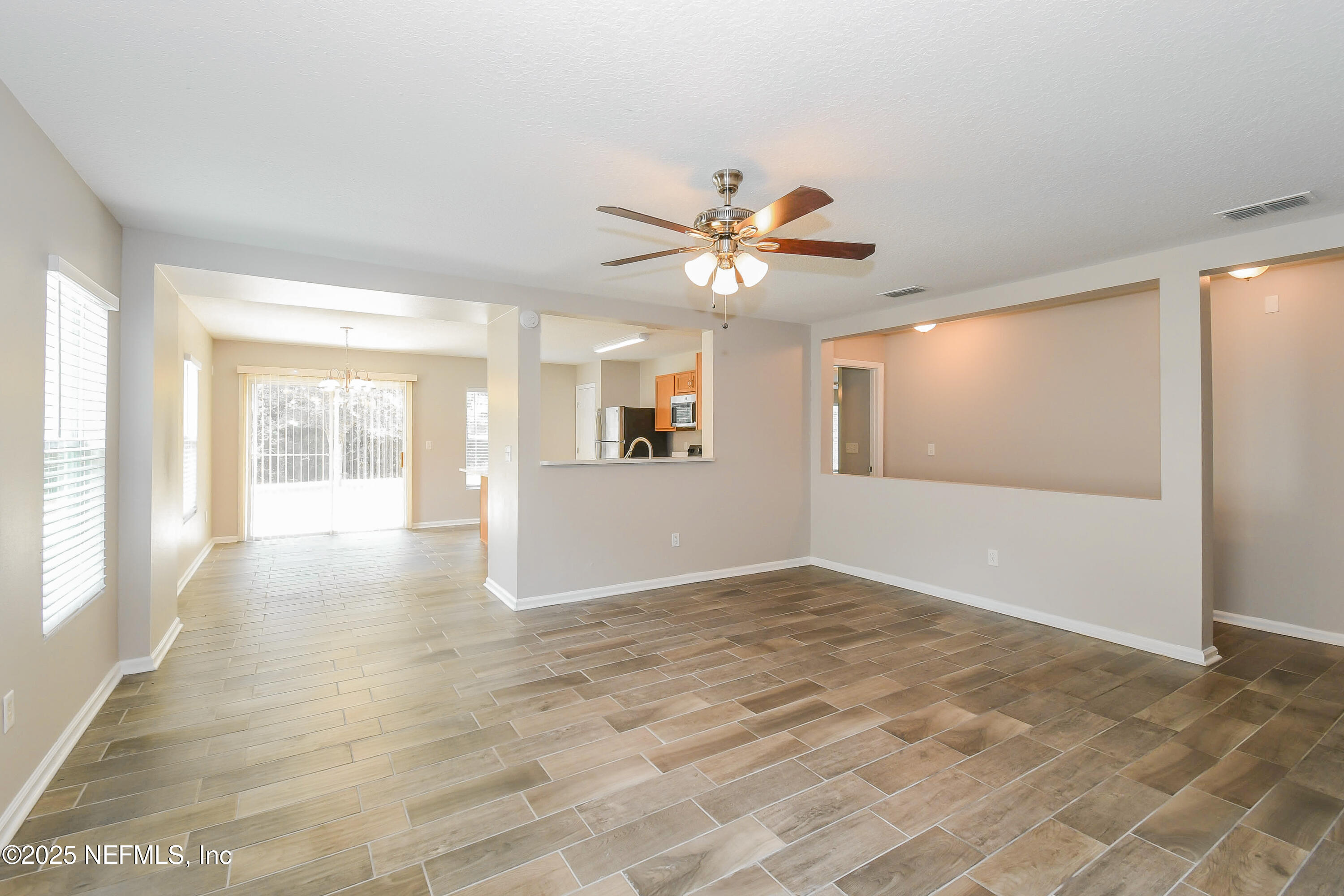 3786 Robena Road Jacksonville, FL 32218 - Photo 4 of 16 wooden floor in an empty room with a window