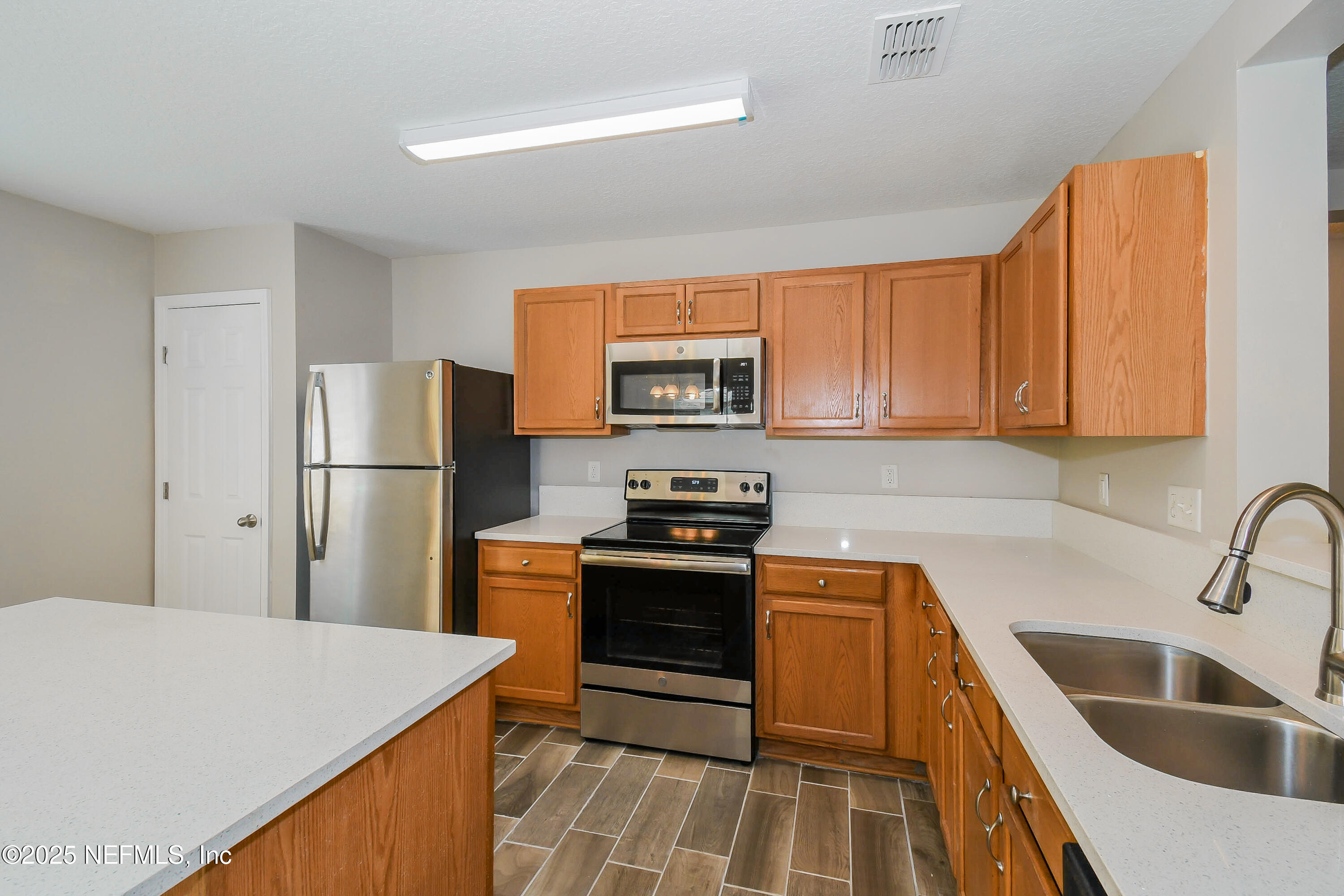 3786 Robena Road Jacksonville, FL 32218 - Photo 7 of 16 a kitchen with stainless steel appliances granite countertop a refrigerator stove and sink