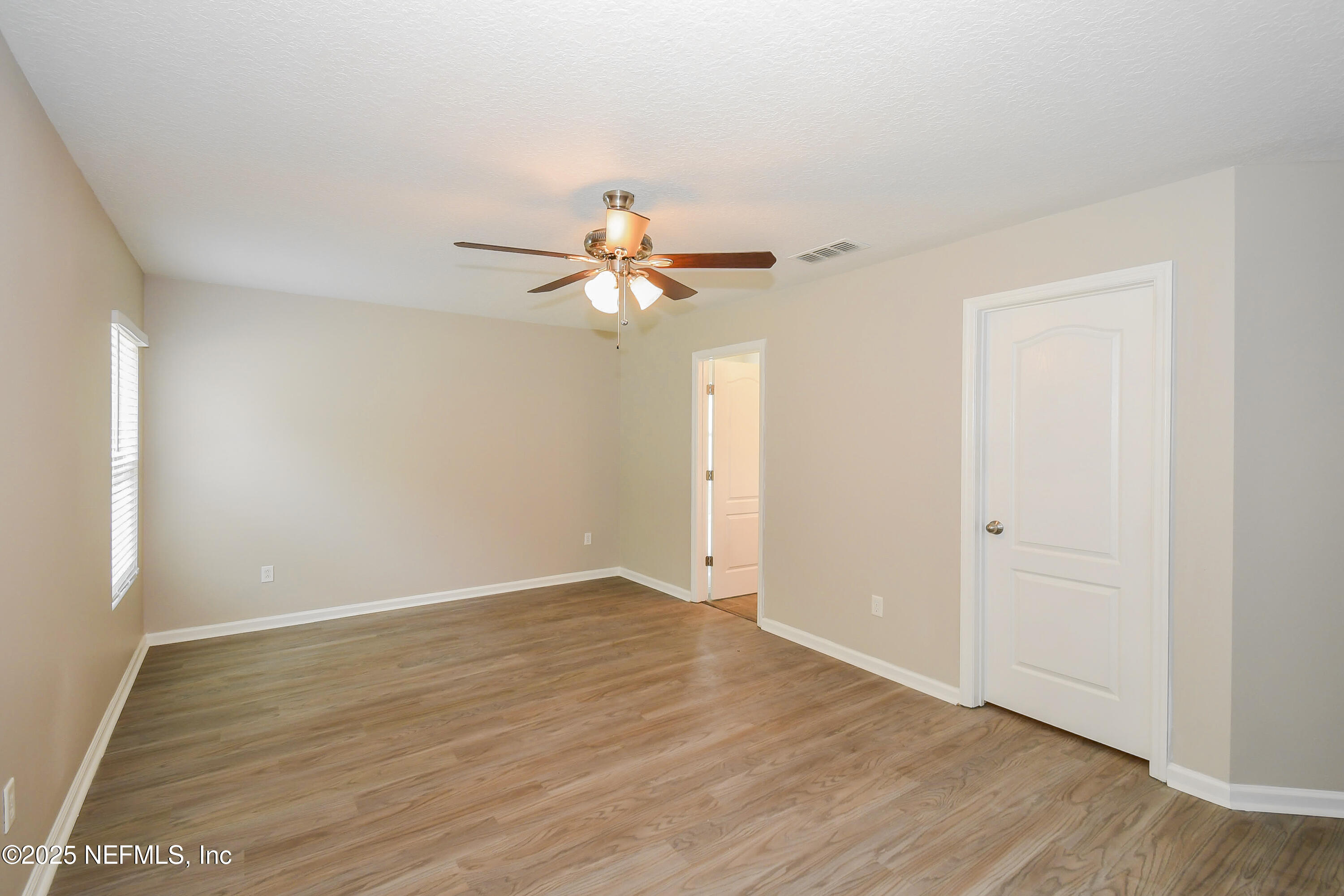 3786 Robena Road Jacksonville, FL 32218 - Photo 8 of 16 a view of a room with wooden floor and a ceiling fan