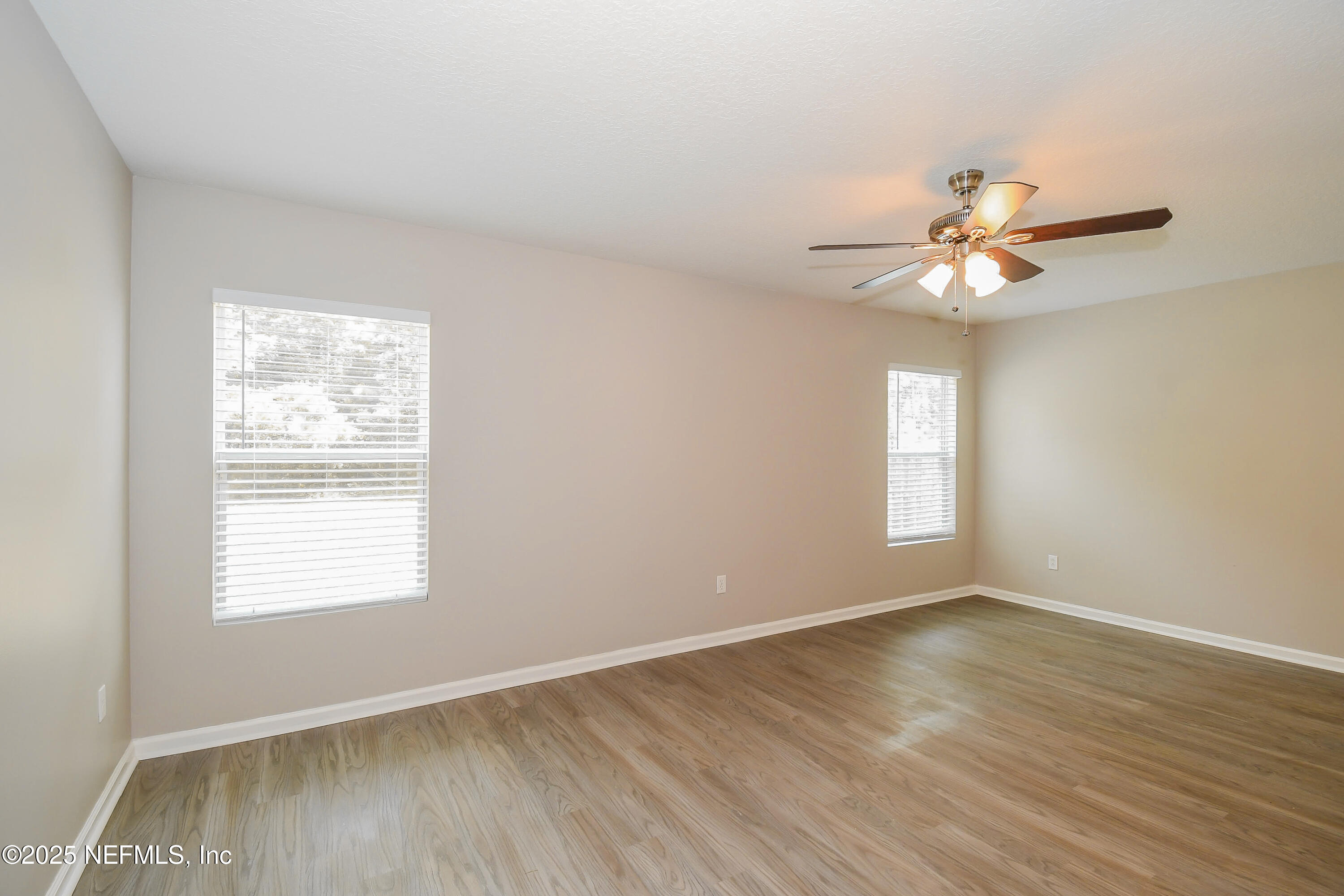 3786 Robena Road Jacksonville, FL 32218 - Photo 9 of 16 a view of an empty room with a window and wooden floor