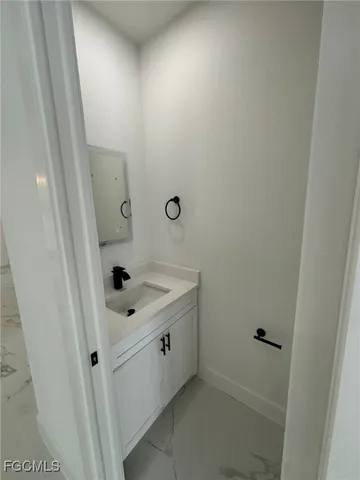 a bathroom with a sink and mirror