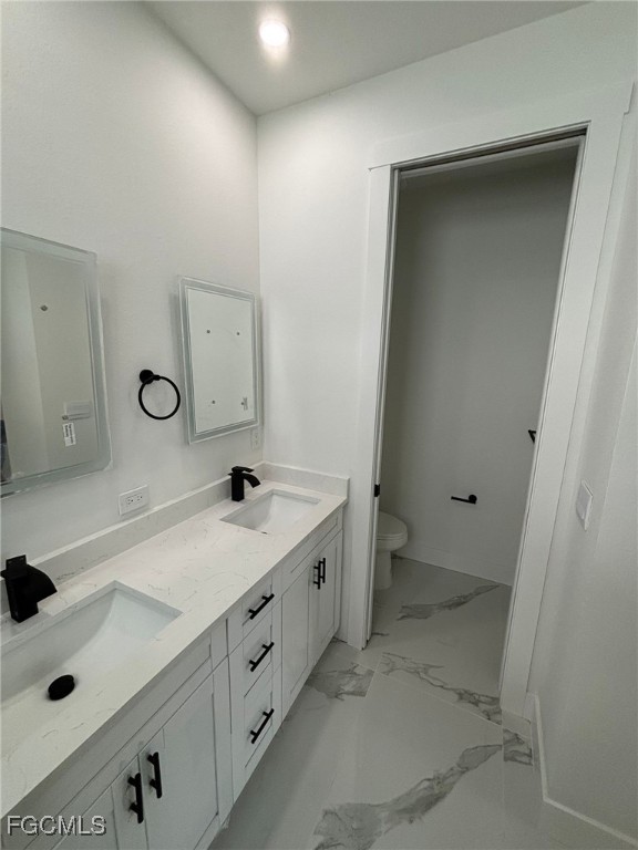1233 Augusta Street East Lehigh Acres, FL 33974 - Photo 15 of 18 a bathroom with a sink and a mirror