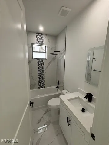 a bathroom with a sink toilet tub and shower