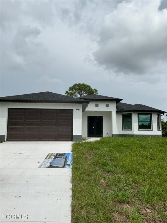 1233 Augusta Street East Lehigh Acres, FL 33974 - Photo 2 of 18 a front view of a house with a yard