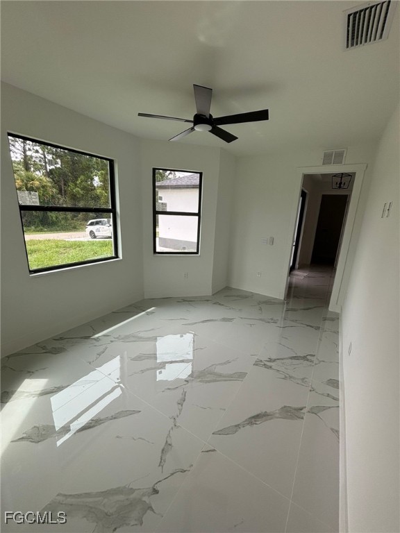 1233 Augusta Street East Lehigh Acres, FL 33974 - Photo 3 of 18 an empty room with windows