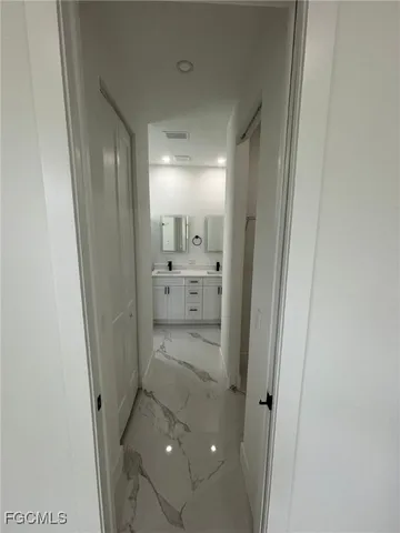 a bathroom with a sink and glass door