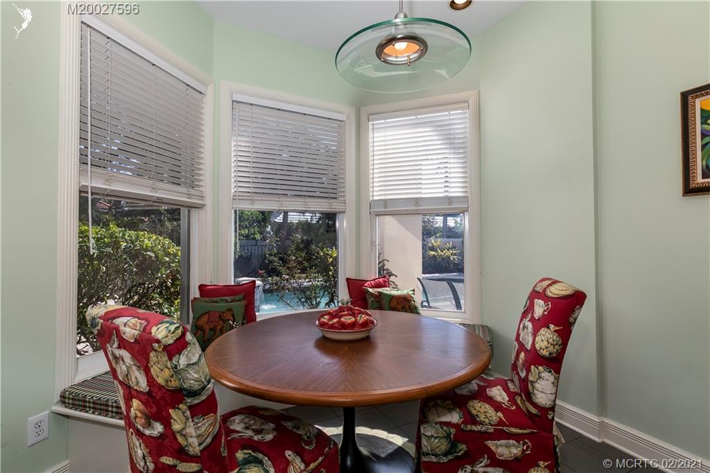 38 West High Point Road Stuart, FL 34996 - Photo 11 of 32 a view of a dining room with furniture window and outside view
