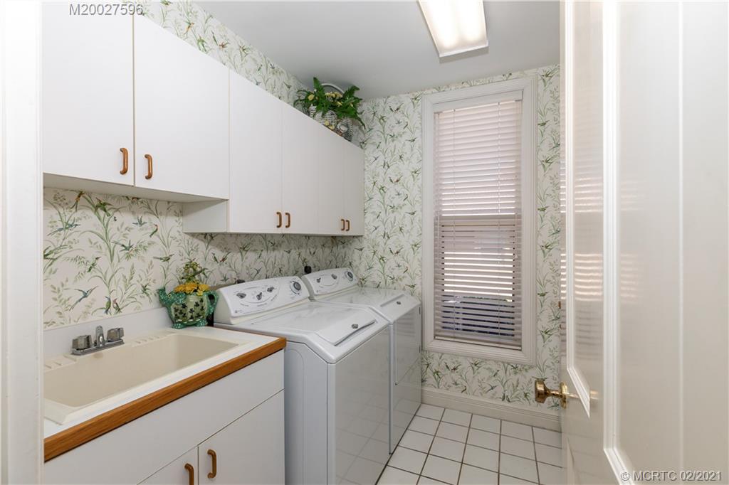 38 West High Point Road Stuart, FL 34996 - Photo 15 of 32 a utility room with cabinets washer and dryer