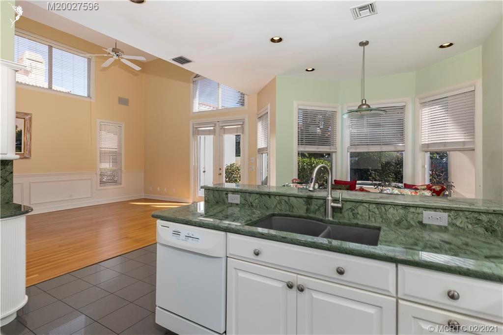 38 West High Point Road Stuart, FL 34996 - Photo 10 of 32 a kitchen with sink cabinets and chandelier