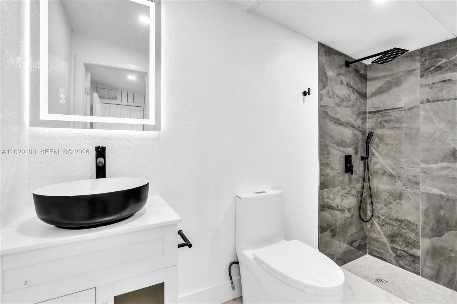 11790 Southwest 34th Street Miami, FL 33175 - Photo 42 of 56 a bathroom with a sink toilet a mirror and shower