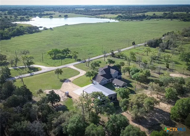 an aerial view of ocean with residential house and outdoor space