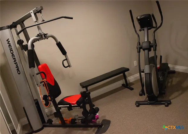 a view of a house with a big yard and large trees