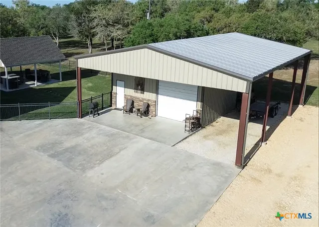 a kitchen with a table chairs and refrigerator