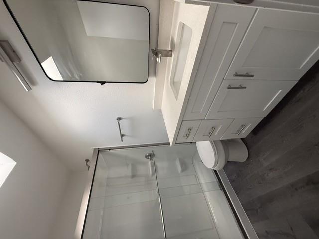 3304 Clawson Road, Unit B Austin, TX 78704 - Photo 10 of 12 A well-appointed bathroom features a modern vanity, spacious shower, and elegant dark flooring.