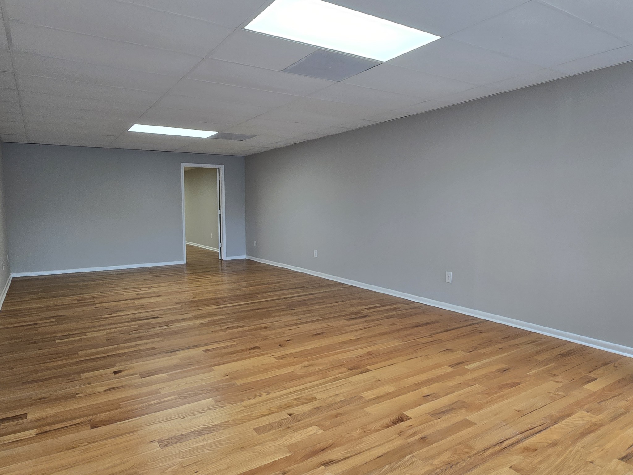 101 South Main Street Mount Pleasant, TN 38474 - Photo 3 of 10 a view of an empty room with wooden floor