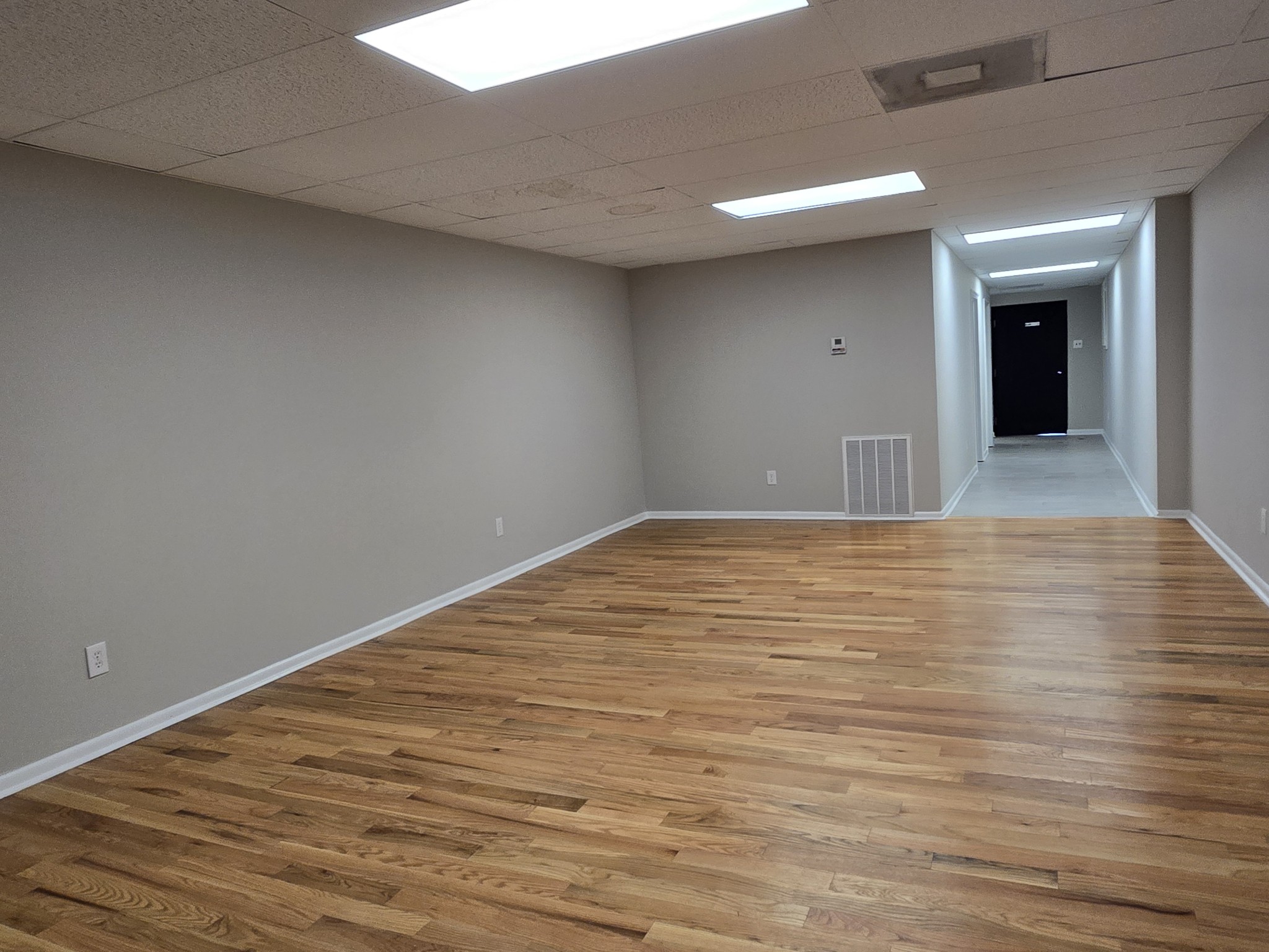 101 South Main Street Mount Pleasant, TN 38474 - Photo 4 of 10 a view of an empty room with wooden floor