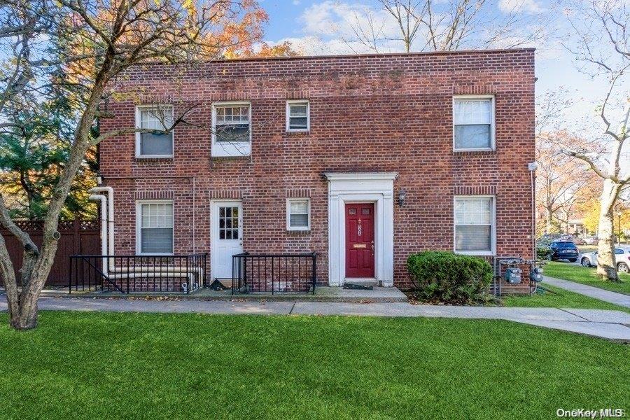 147-14 Charter Road, Unit 30A Queens, NY 11435 - Photo 1 of 1 a brick house with a large windows and a yard