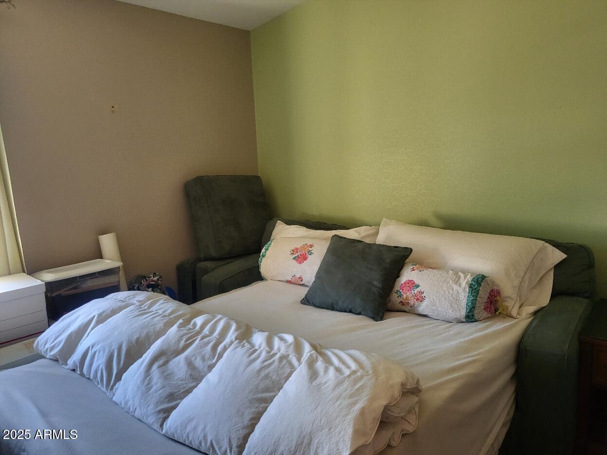 17200 West Bell Road, Unit 2301 Surprise, AZ 85374 - Photo 12 of 29 a bedroom with a bed and a couch