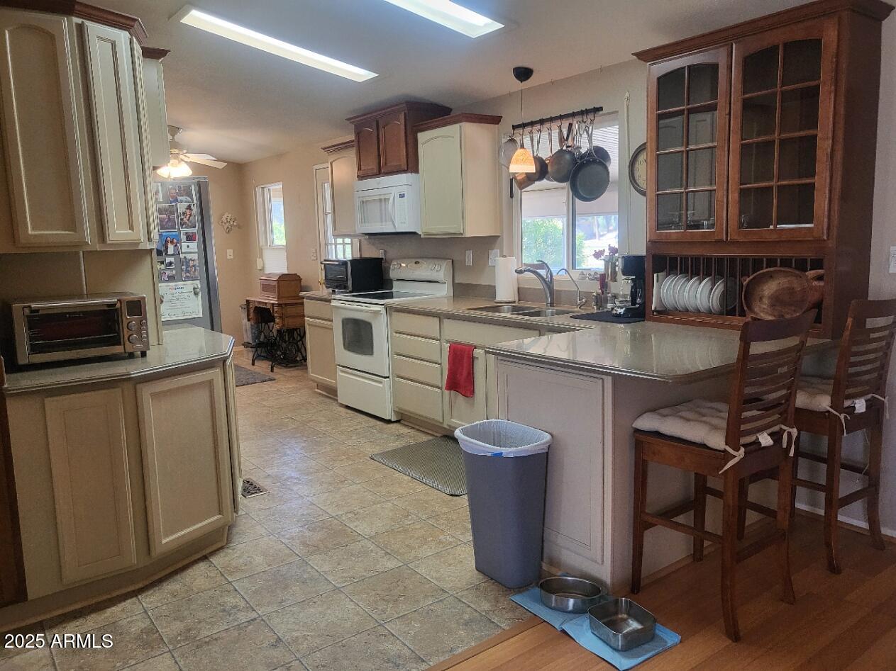 17200 West Bell Road, Unit 2301 Surprise, AZ 85374 - Photo 15 of 29 a kitchen with a sink cabinets and window