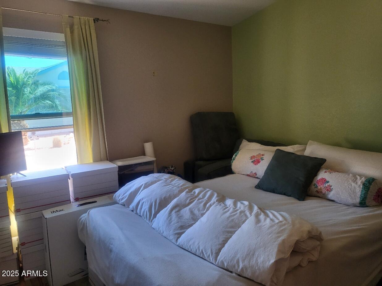 17200 West Bell Road, Unit 2301 Surprise, AZ 85374 - Photo 21 of 29 a bedroom with a bed and a window