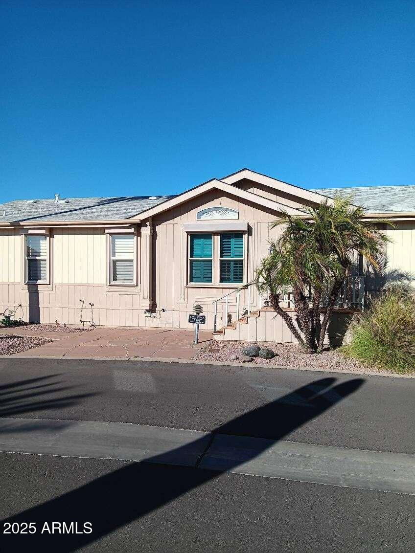 17200 West Bell Road, Unit 2301 Surprise, AZ 85374 - Photo 4 of 29 a front view of a house with yard