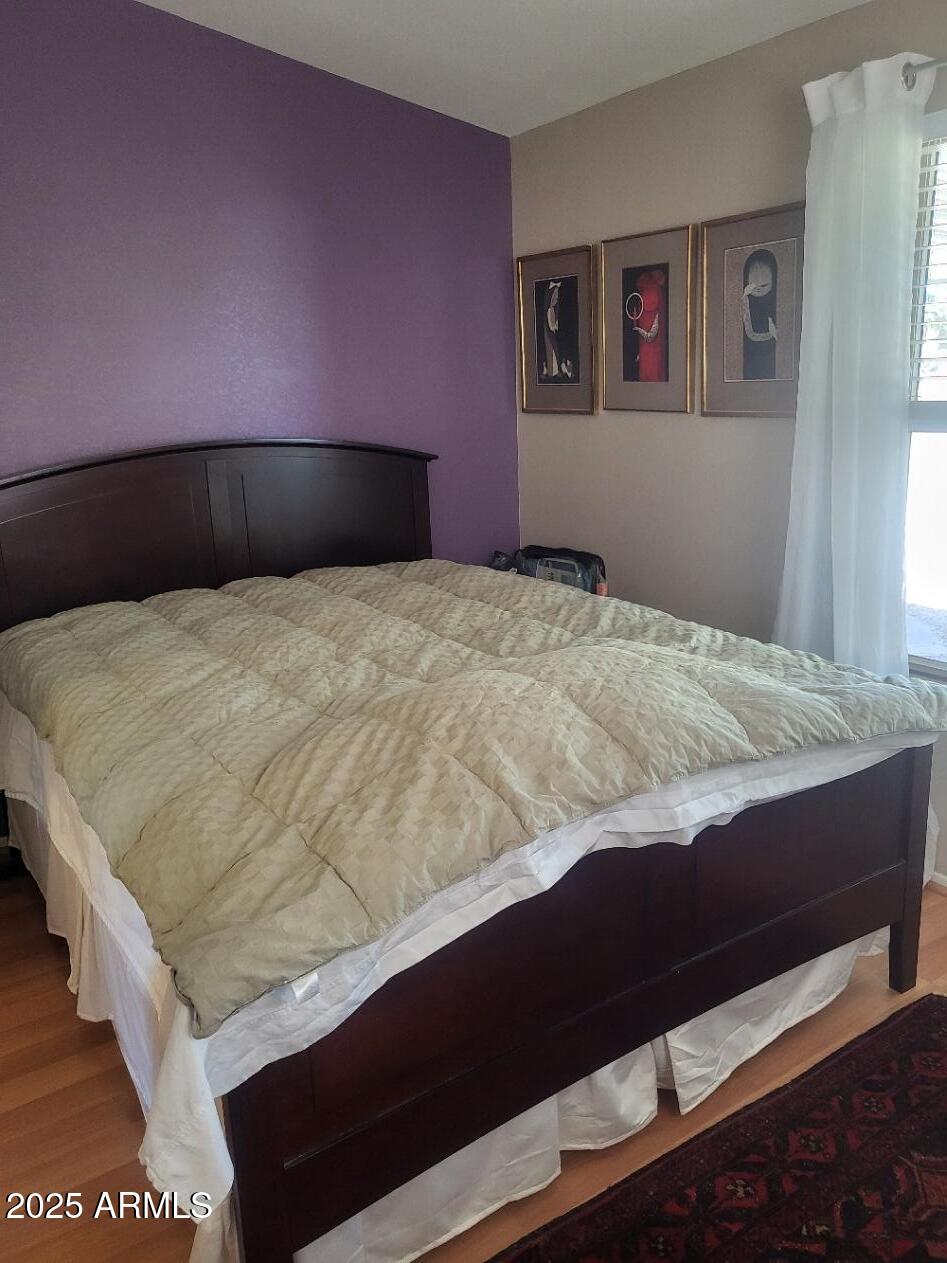 17200 West Bell Road, Unit 2301 Surprise, AZ 85374 - Photo 10 of 29 a bedroom with a bed and painting on the wall