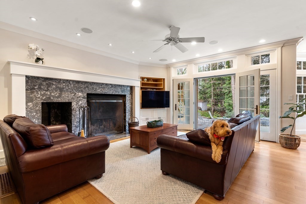 25 Aberdeen Road Weston, MA 02493 - Photo 8 of 40 a living room with furniture a flat screen tv and a fireplace