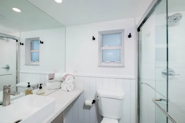 a bathroom with a sink toilet and shower