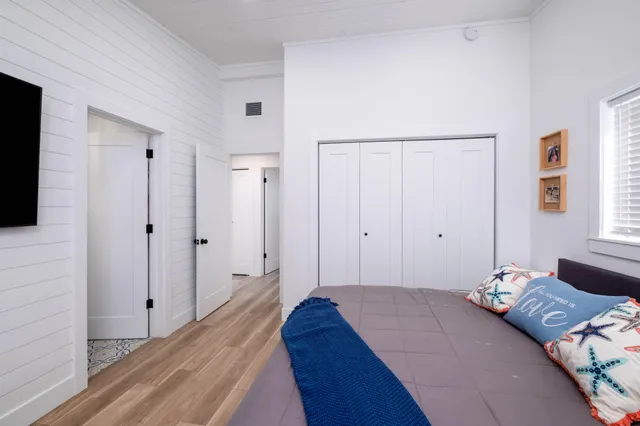 a bedroom with a bed and a flat tv screen