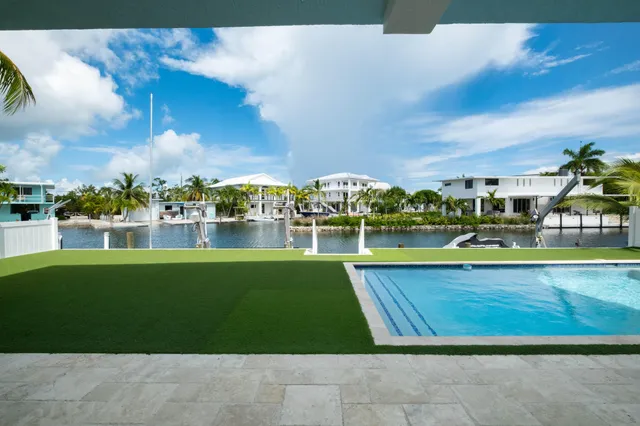 a view of a swimming pool and a yard