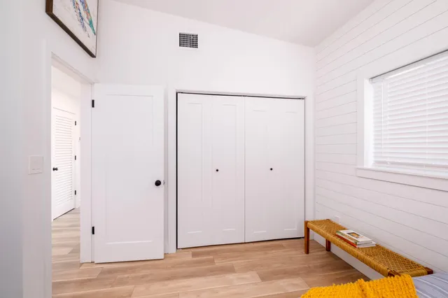 a view of a room with wooden floor