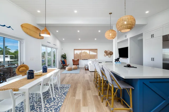 a very nice looking dining room with a large window and chandelier