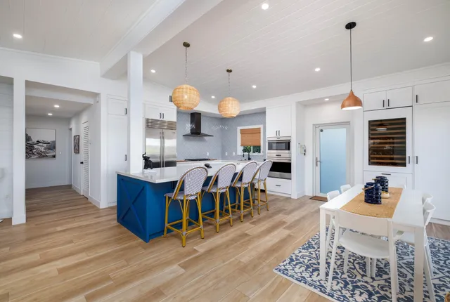 a large kitchen with lots of counter space and furniture