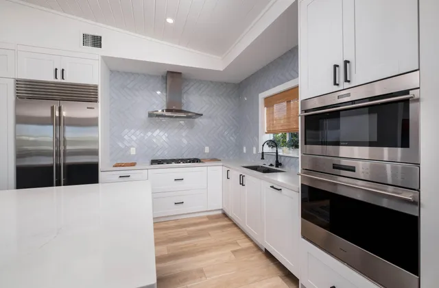 a kitchen with stainless steel appliances kitchen island granite countertop a stove microwave and refrigerator