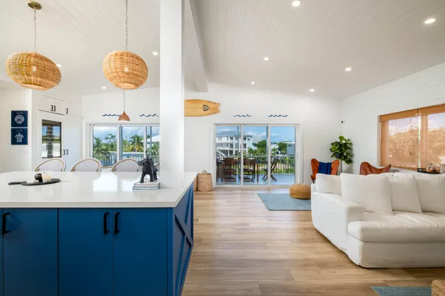 a living room with couches chairs and chandelier