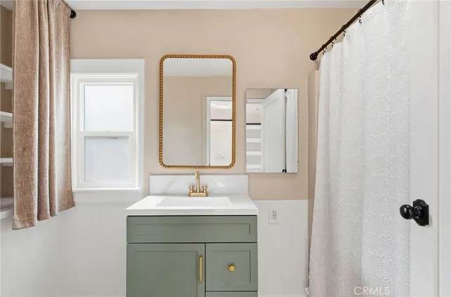 a bathroom with a sink vanity and a mirror