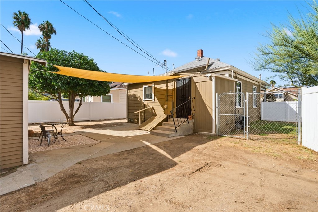 3756 Locust Street Riverside, CA 92501 - Photo 19 of 22 a view of a wooden house with a patio and a yard