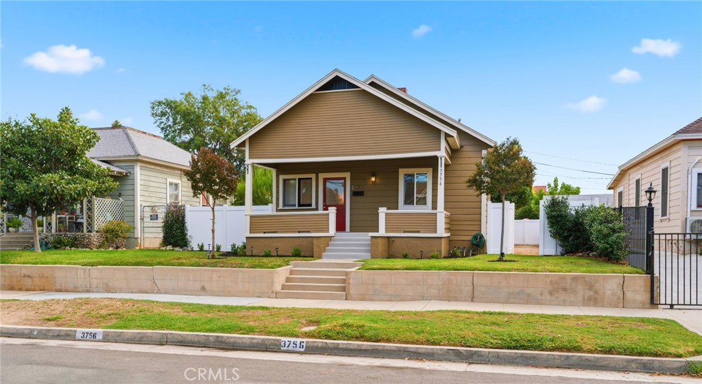 3756 Locust Street Riverside, CA 92501 - Photo 2 of 22 a front view of a house with a yard