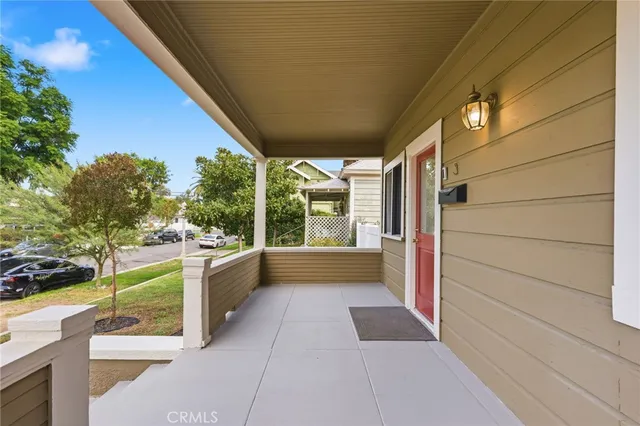 a view of a porch with furniture and a yard